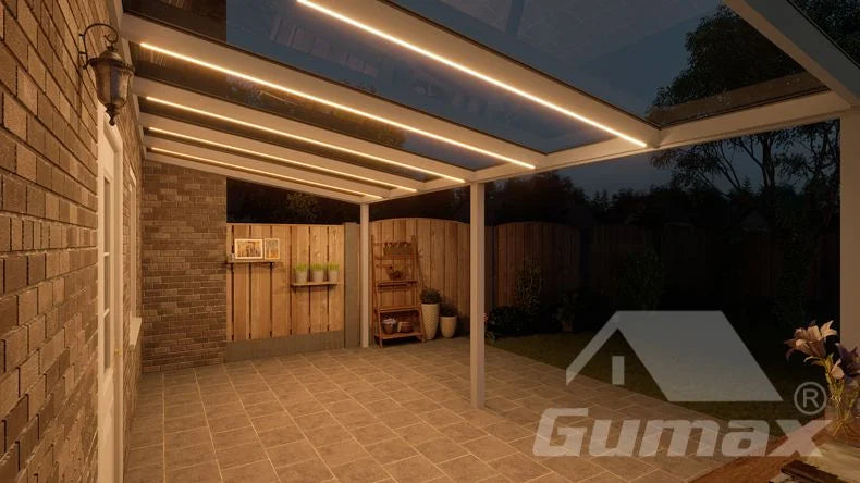 Een avondzicht op een terrasoverkapping met witkleurige lamellen en geïntegreerde LED-verlichting.